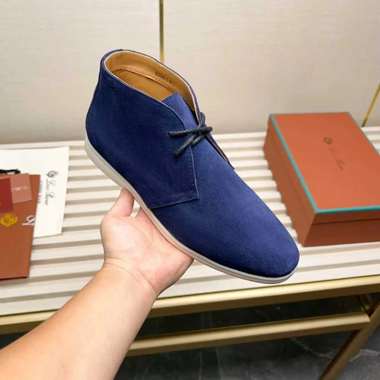 Men's Shoes 💰420 Loro Piana reimagines the desert boot—a modern, comfortable interpretation of a classic 1940s style. Crafted from suede calfskin, it exudes elegance. The tight texture of suede calfskin is not only durable but also looks casual and sophisticated. Add a timeless piece to your shoe collection, harmoniously blending comfort, style and Loro Piana's heritage of craftsmanship. Acetate satin detail on the inside White sole with LP lettering for added traction Space for a personalized signature on the heel Tonal suede trim Upper: 100% cow split suede Sole: 100% Rubber lining: Cow leather
